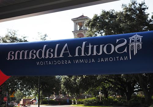 South Alabama National Alumni Association Banner with Moulton Tower in the background.