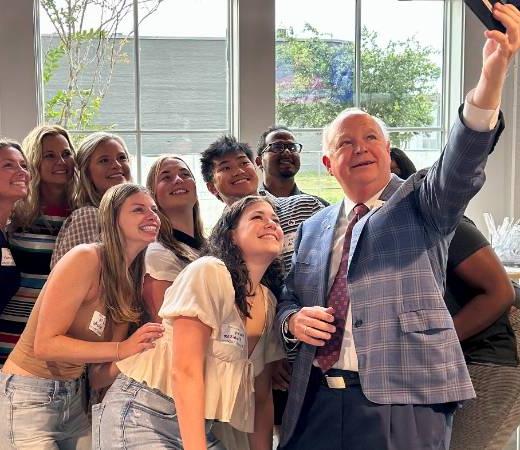 President Bonner taking a selfie with students.